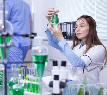 Mature female scientist making scientific test her research lab chemical test tubes 360x320