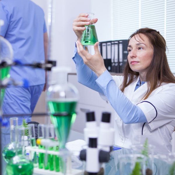 Mature female scientist making scientific test her research lab chemical test tubes 600x600