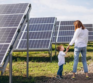 Mother with her little son by solar panels 360x320