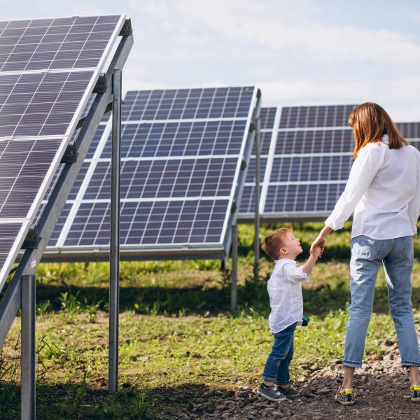 Mother with her little son by solar panels 600x600