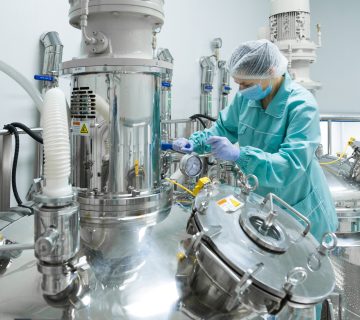 Pharmaceutical factory woman worker protective clothing operating production line sterile environment 360x320